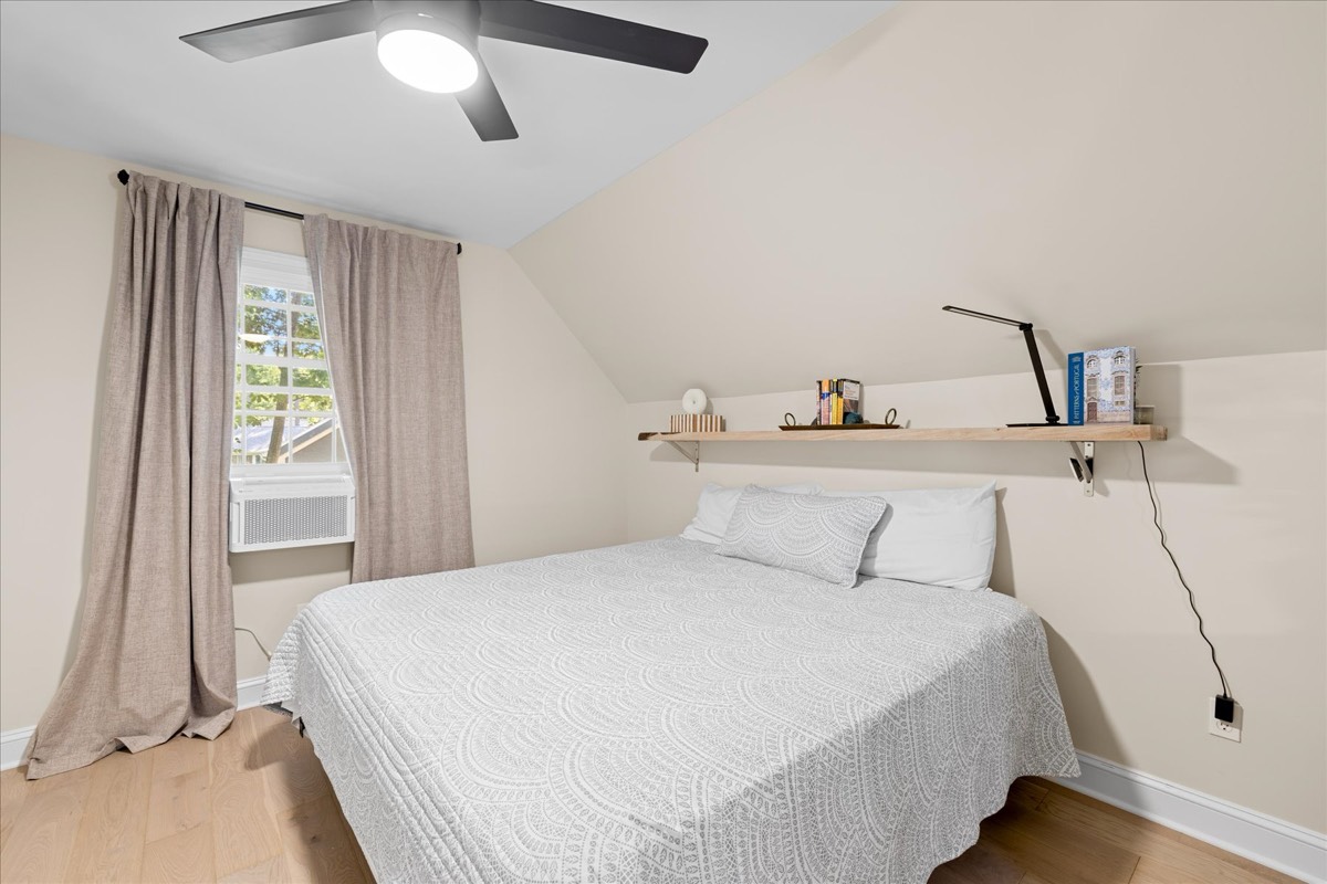 Upstairs bedroom with natural light and ceiling fan